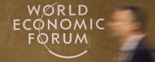 Une personne devant le logo du Forum de Davos.