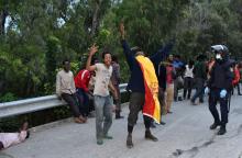 Un membre des forces marocaines poursuit un migrant qui vient de forcer la barrière de l'enclave de 