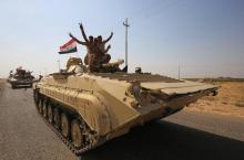 Des forces irakiennes se dirigent vers des positions tenues par les peshmergas kurdes le 15 octobre 