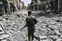 Un membre des Forces démocratiques syriennes dans les décombres de la vieille ville de Raqa le 25 se