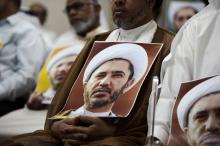 Un Bahreini porte un portrait du leader de l'opposition chiite cheikh Ali Salmane lors d'une manifes
