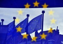 Reflets de drapeaux européens à l'entrée de du siège de la Commission européenne à Bruxelles, le 21 