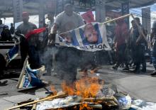 Des partisans du candidat d'opposition Salvador Nasralla brûlent des portraits du président sortant 