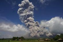 Une colonne de cendres géante s'élève au dessus du volcan Mayon, sur l'île de Luçon aux Philippines, lundi 22 janvier 2018. Des miliers de personnes ont évacué la zone en raison d'un risque d'éruption