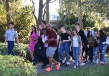 Des élèves quittent le lycée de Marjory Stoneman Douglas, en Floride, après la fusillade meutrière du 14 février 2018