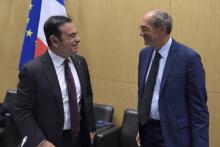 Renault-Nissan Chairman and CEO Carlos Ghosn (L) talks with the head of the French parliament finance commission Eric Woerth as he arrives to attend his hearing by the Economic and Finance commissions
