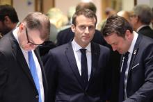 Le président Emmanuel Macron (c) entouré du Premier ministre finlandais Juha Sipila (g) et du Premier ministres du Luxembourg Xavier Bettel, s'entretiennent avant un sommet à Bruxelles, le 23 février 