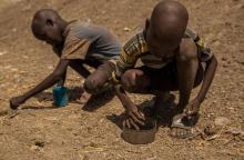 Des enfants ramassent des graines après une distribution de vivres au camp de protection des déplacés sud-soudanais de Bentiu, le 13 février 2018