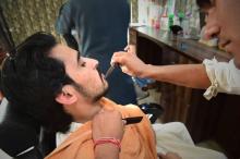 Un barbier pakistanais dans son salon de Peshawar, le 6 mars 2018