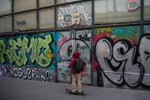 Un jeune skater devant un "narcopiso", appartement servant de lieu de vente de drogues en Espagne, ici à Barcelone dans le quartier de Raval, le 14 février 2018