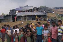 Rohingya Muslims standing at the roadside after arriving at Balukhali refugee camp in Bangladesh: there are fears for hillside shanty settlements during the monsoon season