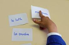 Un enfant autiste s'exerce à lire et à parler, aidé par une orthophoniste dans un institut médico-éducatif à Paris