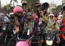 Des femmes pakistanaises manifestent leur joie, le 13 mai 2018 à Lahore, en défilant sur leurs nouvelles mobylettes.