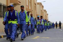 Photo d'ouvriers travaillant sur un site de construction pour le Mondial-2022 de football, le 4 mai 2015 dans la banlieue sud de Doha