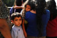 Des familles avec leurs enfants arrivent à une station de bus après avoir été libéré par la police des frontières, le 23 juin 2018 à McAllen au Texas