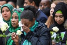 Des proches des victimes lors de commémorations un an après l'incendie de la tour Grenfell, à Londres, le 14 juin 2018