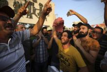Des Irakiens protestent contre la corruption et la déliquescence des services publics le 27 juillet à Bagdad