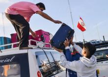 Des Vénézuéliens chargent un véhicule avec leurs affaires avant de fuir vers Tumbes au Pérou, le 23 août 2018