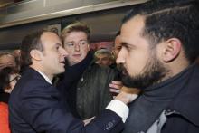 Emmanuel Macron (G), Francois-Xavier Lauch (C) et Alexandre Benalla (D) au Salon de l'Agriculture, Porte de Versailles à Paris, le 24 février 2018