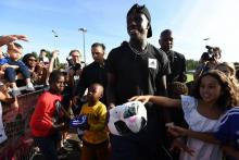 Le défenseur latéral de l'équipe de France acclamé par de jeunes supporters lors d'une visite au club de son enfance à Palaiseau dans l'Essonne, le 10 septembre 2018