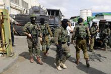 Les forces de sécurité israéliennes se rassemblent sur le site d'une attaque perpétrée par un Palestinien en Cisjordanie occupée, dans la zone industrielle de Barkan, le 7 octobre 2018