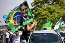 Une partisane (droite) du candidat d'extrême droite Jair Bolsonaro discute avec un partisan (hors cadre) du candidat de gauche Fernando Haddad, lors d'un meeting de campagne du Parti des travailleurs,