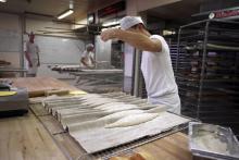 Un jeune apprenti boulanger prépare du pain dans un institut