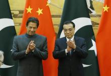 Pakistani Prime Minister Imran Khan and China's Premier Li Keqiang attend a signing ceremony at the Great Hall of the People in Beijing