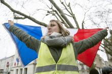 Une manifestante issue des "gilets jaunes" tient le drapeau français lors d'un rassemblement à Nantes, le 22 décembre 2018