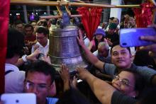 A Balangiga, aux Philippines, la foule prend des photos et essaye de toucher l'une des trois cloches saisies au début du XXème siècle par l'armée américaine que les Etats-Unis viennent de restituer à 