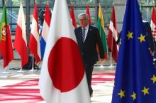 le président de la Commission européenne Jean-Claude Juncker passe près des drapeaux japonais et européen, le 6 juillet 2017 à Bruxelles