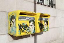 A photo taken on February 11, 2019 in the 13th arrondissement of Paris, shows Anti-Semitic graffiti written on letter boxes displaying a portrait of late French politician and Holocaust survivor Simon