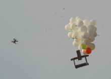 Une photo prise le 19 octobre 2018 à Nahal Oz en Israël, à la frontière avec la bande de Gaza, montre un drone de l'armée israélienne approchant de ballons avec un dispositif incendiaire présumé lancé