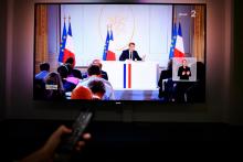 Emmanuel Macron sur un écran de télévision retransmettant sa conférence de presse, le 25 avril 2019 depuis l'Elysée