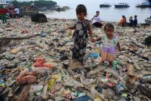 Des enfants au milieu des déchets plastiques dans la baie de Lampung, en Indonésie, le 21 février 2019