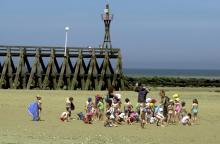 Des enfants en colonie de vacances sur une plage à Courseulles, dans le Calvados en juillet 2003