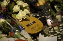 Des fleurs, une guitare et des bougies sont déposées le 15 novembre 2015 en face du Bataclan à Paris en mémoire des victimes des attentats