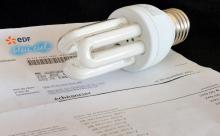 A picture taken on January 6, 2012 in Godewaersvelde, shows an energy-saving light-bulb on a electricity invoice. Recommendations by France's nuclear watchdog agency to beef up safety at plants will c