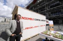 Pierre Botton pose le 27 août 2011 à Paris devant une réplique grandeur nature d'une cellule de prison, dans le cadre de son association