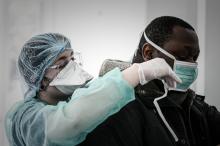Un membre du personnel soignant s'apprête à tester un patient, à Paris le 27 mars 2020