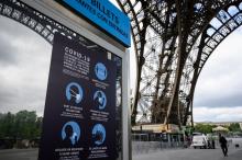 Les consignes sanitaires visibles près de la file d'attente de la Tour Eiffel, le 15 juin 2020 à Paris, avant la réouverture partielle du monument au public