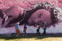 Des visiteurs devant une des fresques de Street Art City le 3 septembre 2020 à Lurcy-Lévis
