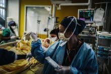 Des équipes médicales s'occupent d'un patient dans l'unité de soins intensifs de l'hôpital Lariboisière, le 14 octobre 2020 à Paris
