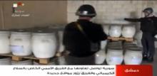 Un inspecteur de l'OIAC dans un lieu tenu secret en Syrie sur une capture d'écran de la télévision syrienne le 19 octobre 2013