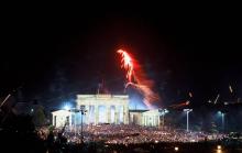 Liesse populaire à minuit a Berlin, pendant la nuit de la réunification allemande le 3 octobre 1990.
