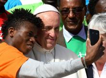 Le pape François pose avec un membre de Caritas Internationalis pendant l'audience générale sur la p