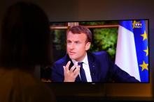 Une femme regarde le 15 octobre 2017 à Rennes une interview télévisée d'Emmanuel Macron