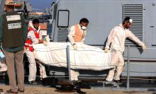 Des gardes-côtes libyens transporte le corps d'un migrant, mort dans le naufrage d'une embarcation, 