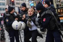 Des policiers turcs anti-émeute arrêtent une femme au cours d'une manifestation organisée à Istanbul par le parti pro-kurde, le HDP, pour protester contre l'opération "Rameau d'olivier" en Syrie, le 2