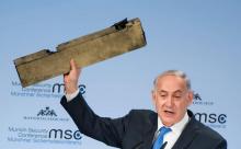 Le Premier ministre israélien Benjamin Netanyahu brandit un morceau de métal présenté comme provenant d'un drone iranien abattu par Israël, le 18 février 2018 pendant la Conférence de Munich sur la sé